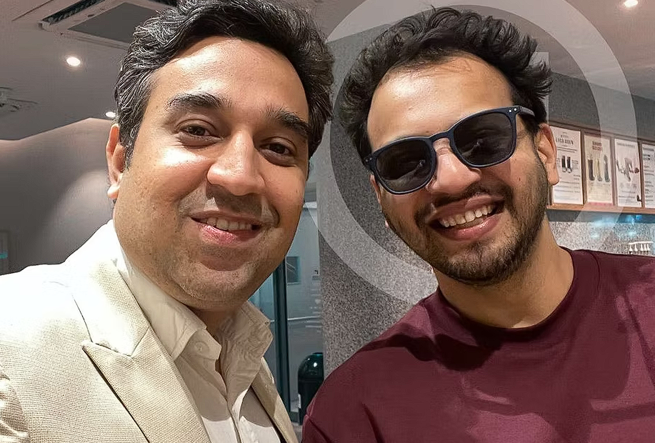 2 men smiling at camera